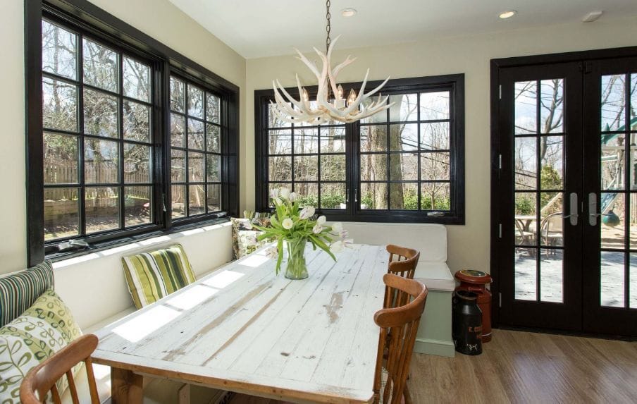 Black framed casement windows in a dining room