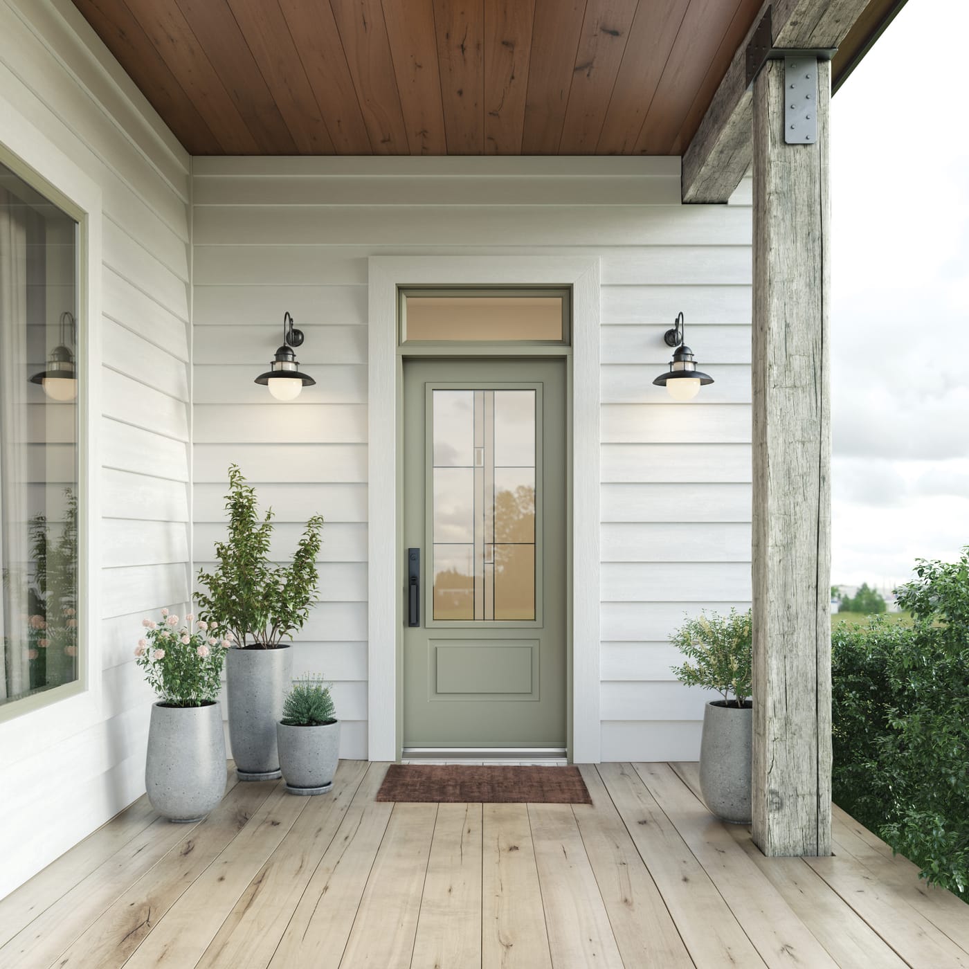 A sage green entry door with Arima decorative glass and a transom above, on a covered porch