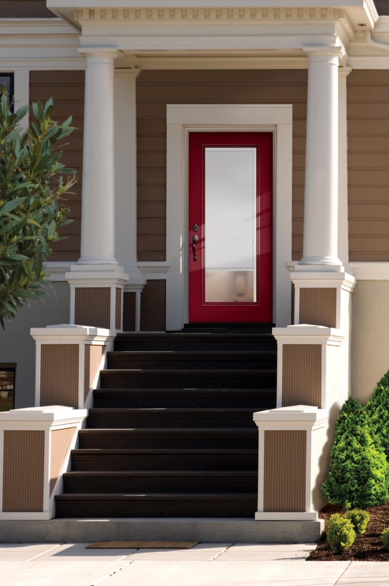 An entry door with white mini blinds sealed in the glass
